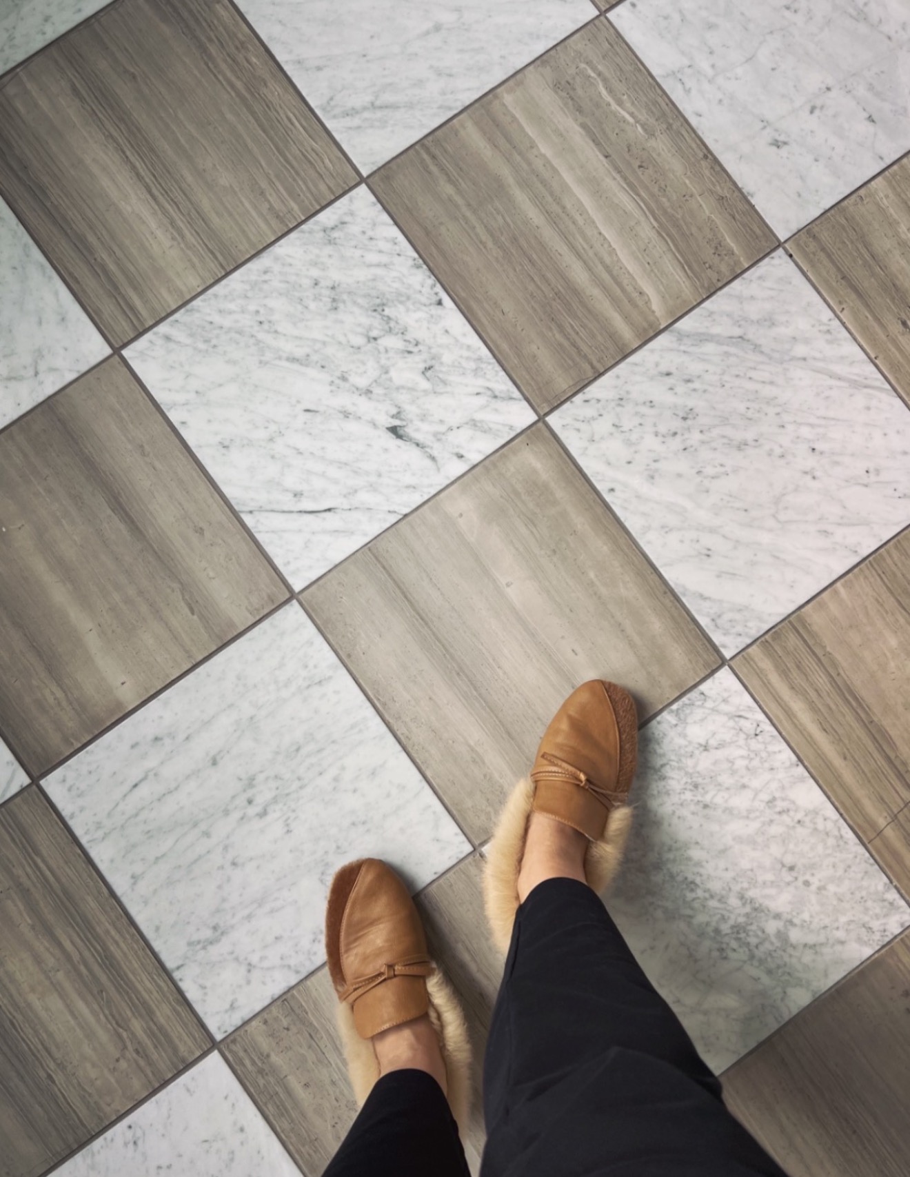 Checkerboard marble and limestone tile floor laid on the diagonal